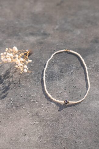 Pearl necklace with a single black Pearl in the center
